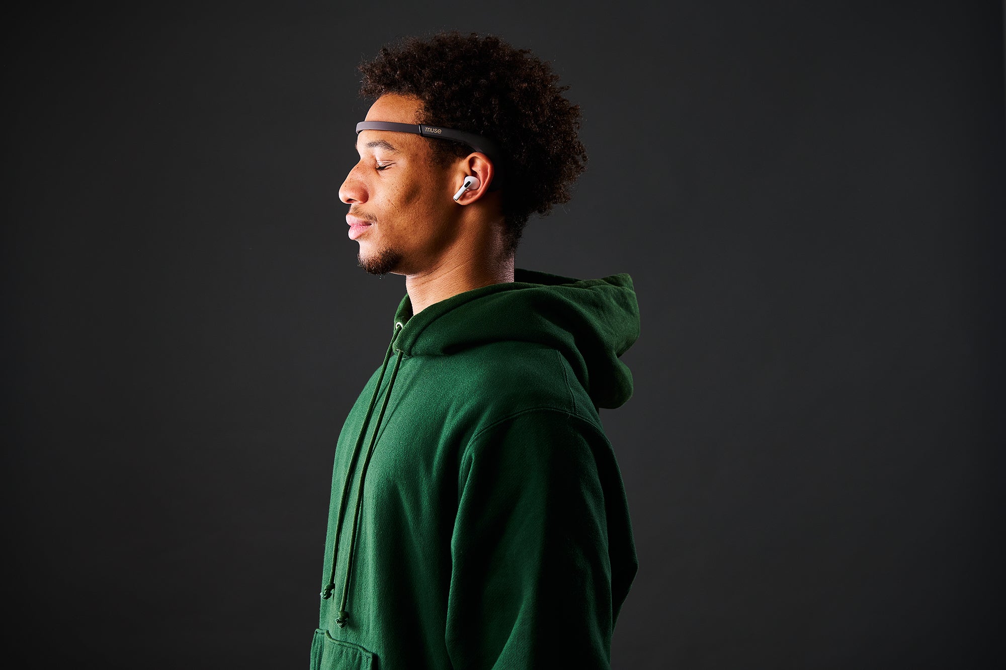 Man practising mental fitness with Muse S Athena headband in green hoodie
