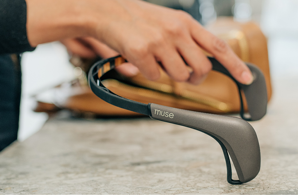 A person reaching for Muse 2 Headband